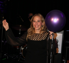 Kelly Stetler prepares to pop a purple balloon for the Split-the-POP! drawing